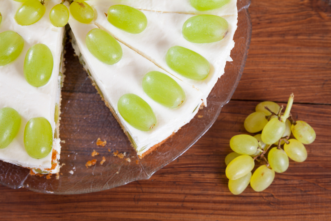 Grape torte with green grapes on cake plate